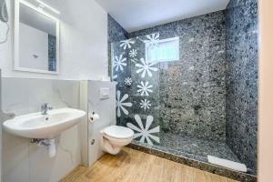 a bathroom with a sink and a toilet and a shower at Villa Mirena in Kožino +144 photos