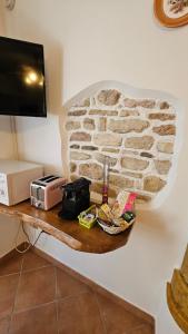 a wall with a shelf with a stone wall at Casa Angelo in Torri del Benaco