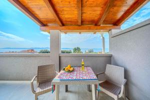 a table and two chairs on a balcony at Villa Mirena in Kožino