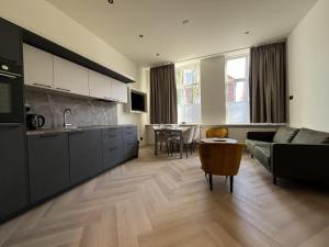 a kitchen and living room with a couch and a table at Appartementen het Centrum in Domburg