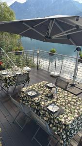 a table and chairs under an umbrella on a deck at Adeline in Dascio