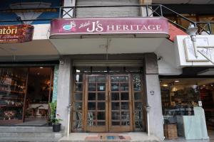 a store front with a us heritage sign above the doors at Hotel J'S Heritage in Kodaikānāl
