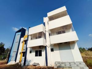 a white building with shutters on it at RV Comforts in Siruvāchchūr
