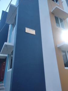 a blue building with a sign on the side of it at RV Comforts in Siruvāchchūr