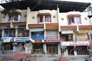 a large building with shops on a city street at Hotel J'S Heritage in Kodaikānāl