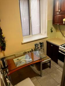 a small kitchen with a glass table and a chair at City Relax 2 in Bălţi +22 photos