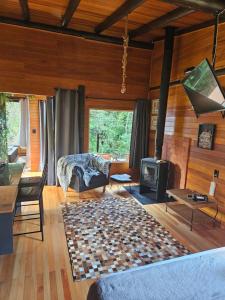 a living room with a fireplace and a stove at Sentiero Cabanas Boutique in Urubici