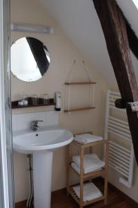 a bathroom with a sink and a mirror at La Table de Gabin in Saint-Léonard