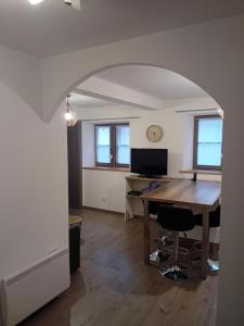 an office with a desk and a table in a room at Le Bredele in Riquewihr