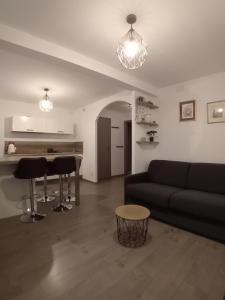 a living room with a couch and a table at Le Bredele in Riquewihr +10 photos