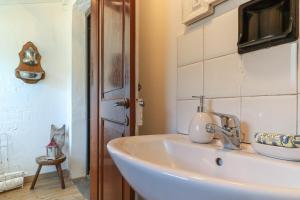 a bathroom with a white sink and a mirror at Bnbook Ca Du Val in Falmenta