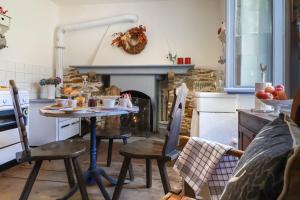 a kitchen with a table and chairs and a fireplace at Bnbook Ca Du Val in Falmenta +37 photos