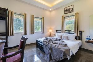 a bedroom with a bed and two windows at Virasat-1969 in Udaipur +70 photos