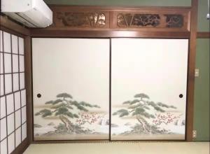 a door with a painting of a tree on it at RYU in Hatsukaichi