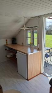a kitchen with a counter top in a house at Tåsingecamping og Grill in Svendborg