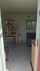 a living room with a table and chairs and a couch at Tåsingecamping og Grill in Svendborg