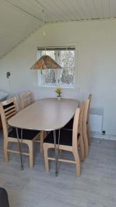 a dining room table and chairs in a room at Tåsingecamping og Grill in Svendborg