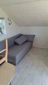 a couch in a small room with a table at Tåsingecamping og Grill in Svendborg