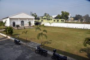 a group of motorcycles parked in front of a yard at Hotel Royal Maithan International in Garphalbāri +5 photos