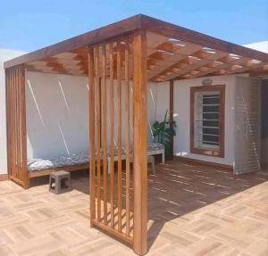 a wooden gazebo on a patio at Romantique place in Mahdia +2 photos