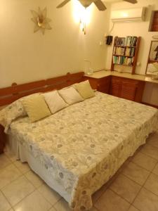 a bedroom with a large bed in a room at Golden Gem Cosy Apartment with pool & garden view in Saint James +16 photos