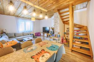 a living room with a couch and a table with chairs at Chata Dolinka in Liptovské Revúce