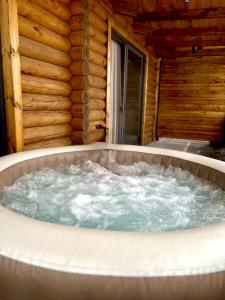 a jacuzzi tub in a log cabin at Homma Aparan with Superpool, 30 min from Yerevan in Aparan