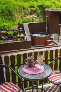 a table with a candle and flowers on a patio at Chata Dolinka in Liptovské Revúce