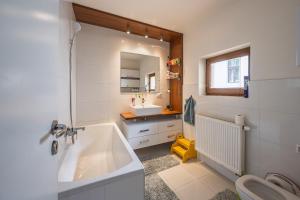 a bathroom with a tub and a sink and a toilet at Chata Dolinka in Liptovské Revúce