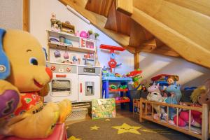 a toy kitchen with a teddy bear in a room at Chata Dolinka in Liptovské Revúce