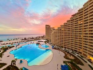 a view of a resort with a pool and the ocean at Porto Sokhna Pyramids - For Families Only vip in Ain Sokhna