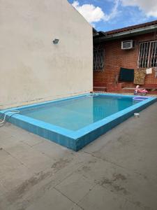 an empty swimming pool in a yard at Guest House da Amazônia in Manaus