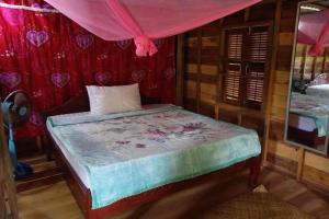 a bedroom with a bed with a pink canopy at Authentic Cambodian Angkor Cottage in Siem Reap +20 photos