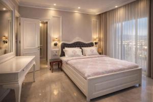 a bedroom with a large bed and a window at Lion Park Suites & Residence Hotel in Aydın +20 photos