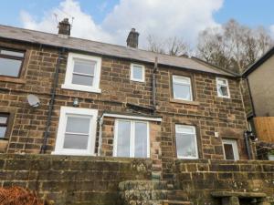 an old brick house with white windows at Natures Retreat in Matlock