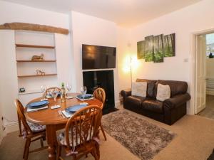 a living room with a table and a couch at Natures Retreat in Matlock