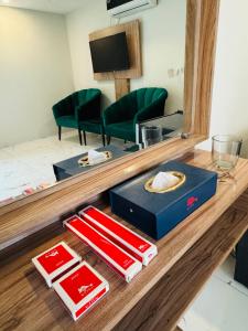 a table with a mirror and a box on it at Nuva Hotel-DHA 2 in Islamabad +42 photos
