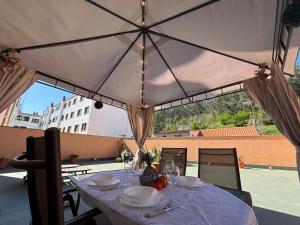 a table with plates of food on top of a patio at Apartamento Estela in Combarro