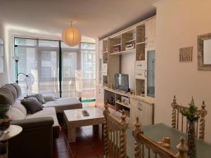 a living room with a couch and a table at Apartamento Estela in Combarro