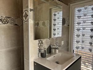 a bathroom with a sink and a mirror at Maison chez Louis in Asuel +32 photos
