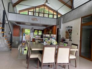 a kitchen and dining room with a table and chairs at Iluka 2- By the Bay in Puerto Galera