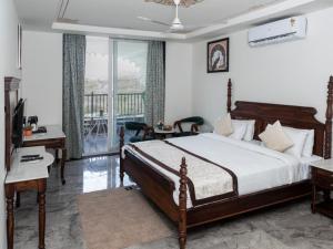 a bedroom with a bed and a balcony at Jaisamand Garh Resort in Udaipur +10 photos