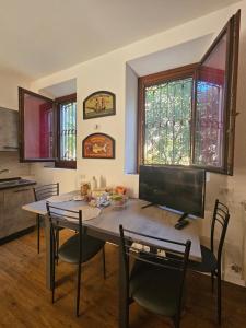 a kitchen with a table with chairs and a television at B&B A due passi dal centro in Castelfidardo +17 photos