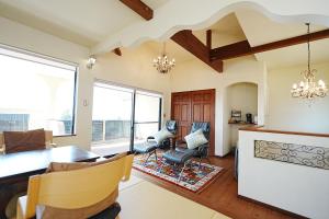 a living room with a table and chairs at 天からの贈り物 VillaMontpetre in Kirishima