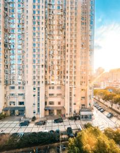 a large building with a parking lot in front of it at Pu Yu Apartment in Shanghai