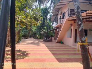 a street with a car parked next to a building at Shraddha Cottage in Nagaon