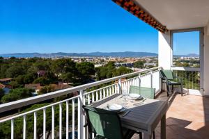 a table and chairs on a balcony with a view at Panorama Majestic in Saint-Raphaël