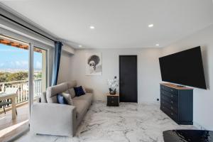 a living room with a couch and a flat screen tv at Panorama Majestic in Saint-Raphaël
