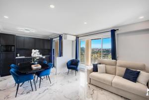 a living room with a couch and a table at Panorama Majestic in Saint-Raphaël