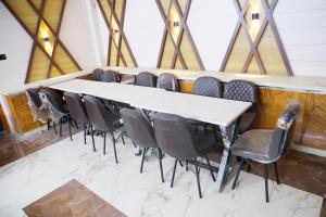 a conference room with a long table and chairs at Pragati Guest House in Gorakhpur